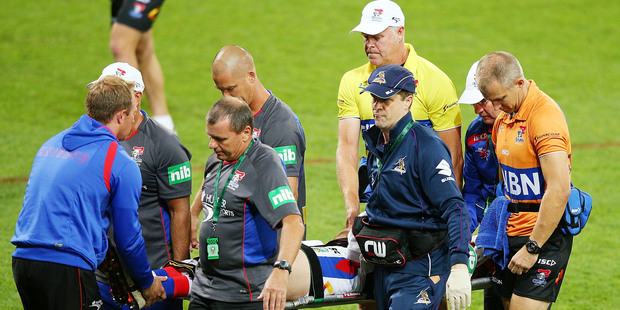 Alex McKinnon of the Knights is carried off an a stretcher. Photo / Getty Images