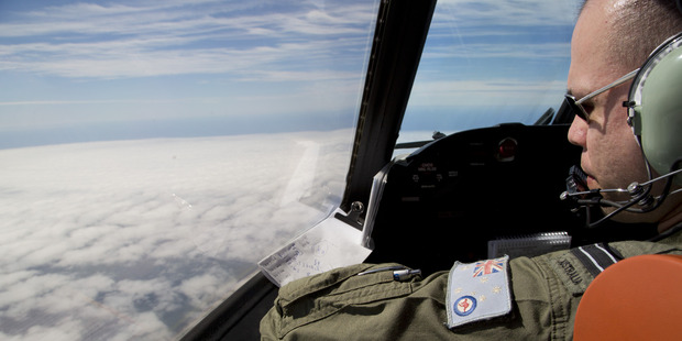 Flight Lieutenant Jayson Nichols looks out of the cockpit of a Royal Australian Air Force AP-3C Orion. Photo / AP