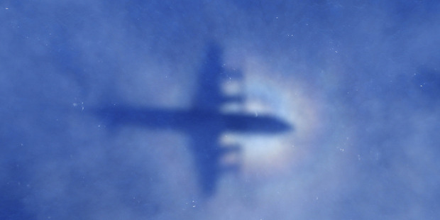 A shadow of the Royal New Zealand Air Force P3 Orion aircraft is seen on low cloud cover while it searches for missing Malaysia aircraft. Photo / Getty Images