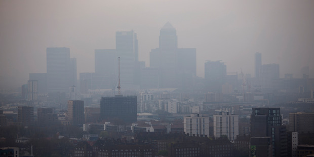 The skyscrapers of the Canary Wharf business district in London are shrouded in smog. Photo / AP