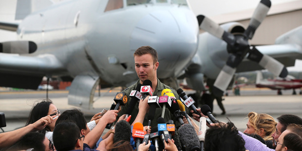 Royal Australian Air Force pilot Flight Lt. Russell Adams speaks to the media. Photo / AP
