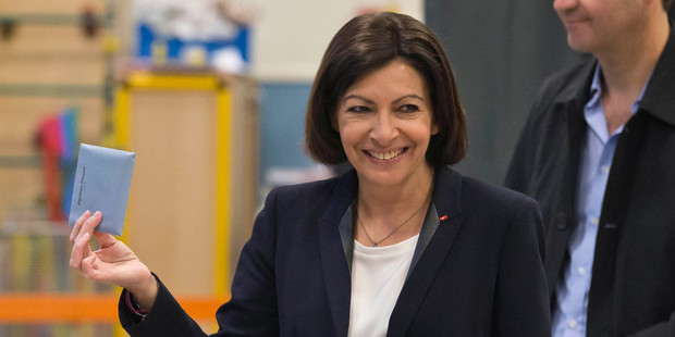 Anne Hidalgo shows her ballot to the media before casting it during the municipal elections in Paris. Photo / AP