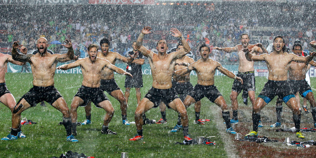 The New Zealand rugby team dance after winning the Hong Kong Sevens rugby tournament against England in Hong Kong, Sunday, March 30, 2014. (AP Photo/Kin Cheung)