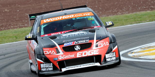 Greg Murphy in action at the V8 SuperTourers and proudly posing with his winner's trophy.