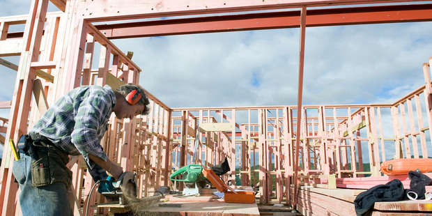 A builder works on the construction site of the Aotea block residential development in Porirua City. Photo / Mark Coote