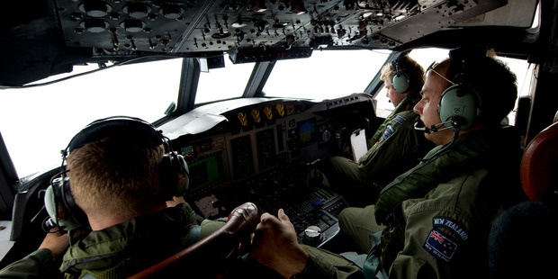 Royal New Zealand Air Force (RNZAF) aircrew on the flight deck of the P-3K2 Orion conducts a visual search.