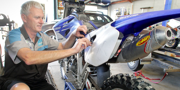 Shane Sinclair of D and M Autos, Hastings, checks over his Yamaha WR450F before the fundraising trail ride he had organised for the Lowe Corporation Rescue Helipcopter.