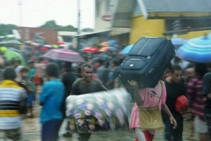 Looters in Honiara's Chinatown help themselves after the storm.