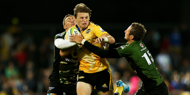 Beauden Barrett of the Hurricanes is tackled by Bjorn Basson (L) and Jurgen Visser of the Bulls during the round eight Super Rugby match between the Hurricanes and the Bulls. Photo / Getty Images.