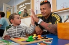 HIGH FIVE: Ross Winitana-MacKinnon, 2, from Hastings high-fives Hurricanes player Faifili Levave during the team's visit to Hawke's Bay Hospital. PHOTO/GLENN TAYLOR HBT140876-06 HIGH FIVE: Ross Winitana-MacKinnon, 2, from Hastings high-fives Hurricanes player Faifili Levave during the team's visit to Hawke's Bay Hospital. PHOTO/GLENN TAYLOR HBT140876-06