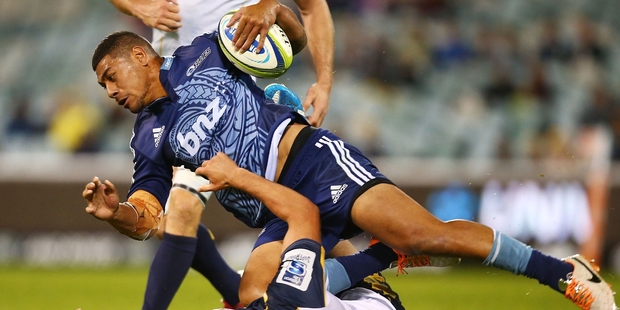 The Blues' Charles Piutau runs over Lachlan McCaffrey of the Brumbies in their clash at Canberra. Photo / Getty Images