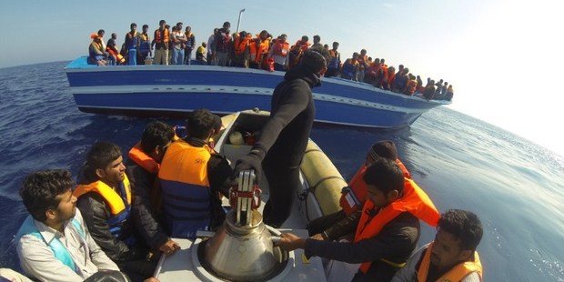 Immigrants stand on a boat during a rescue operation off the coast of Sicily on October 30, 2013. Photo / AFP