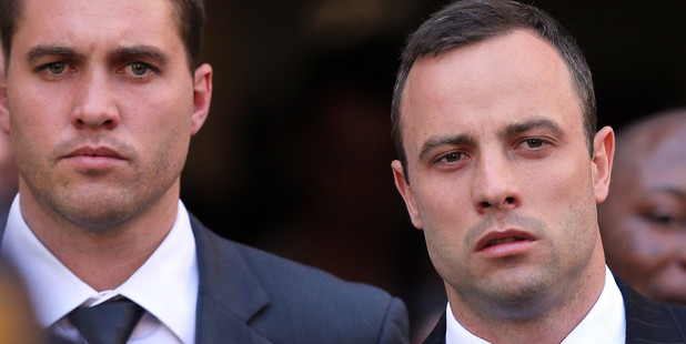 Oscar Pistorius, right, leaves the the high court in Pretoria, South Africa. Photo / AP
