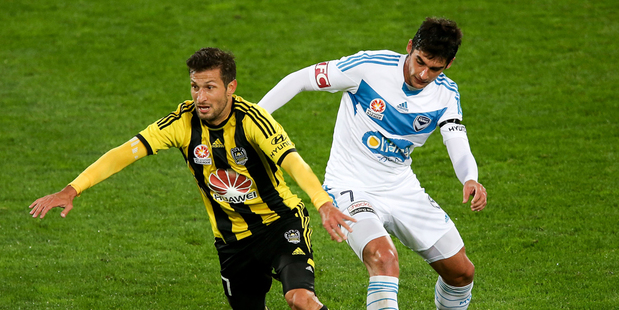 Vince Lia of the Phoenix beats the defence of Guilherme Finkler of the Victory during the round 27 A-League match between Wellington Phoenix and Melbourne Victory. Photo / Getty Images.