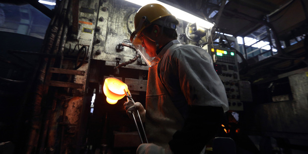 A Toyota worker forges a car part by hand. Photo / Bloomberg
