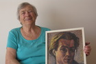 Dora Bakkenes holding a self-portrait of her late husband Walter Bakkenes. Dora Bakkenes holding a self-portrait of her late husband Walter Bakkenes.