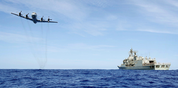A Royal Australian Air Force AP-3C Orion from 92 Wing, conducts a low level fly by before dropping stores to HMAS Toowoomba. Photo / AP