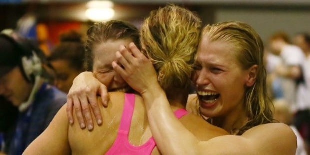 Ellen Quirk and Samantha Lucie-Smith of the women's 4x100m relay team celebrate with team mate Laura Quilter after qualifying for the Commonwealth Games. Photo / Simon Watts