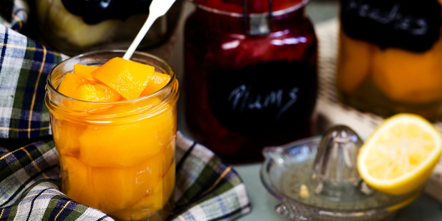 Preserved peaches. Agee jars from Flotsam & Jetsam Ph (09) 361 3831, Fog linen tea towel from Father Rabbit Ph (09) 360 2573. Food stylist / Angela Casley. Photographer and prop stylist / Babiche Martens.