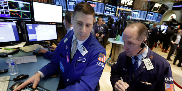 Specialist and trader on the floor of the New York Stock Exchange. Photo / AP