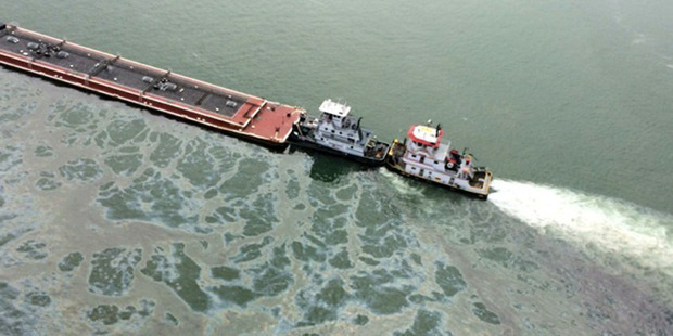 A barge loaded with marine fuel oil sits partially submerged in the Houston Ship Channel. Photo / AP