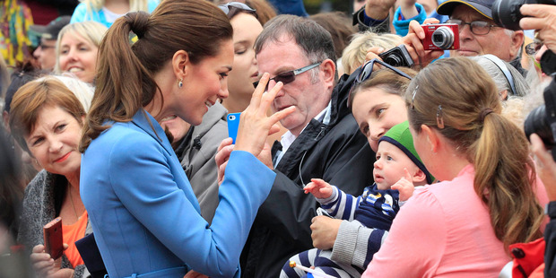 Kate, the Duchess of Cambridge, waves as she and Prince William attend a wreath laying ceremony and public walk in Blenheim. Photo / AP