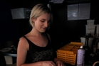 Napier's Ujazi Cafe waitress Kimberley Holdershaw-Phipps prepares cutlery in the dark while she waits for the power to be restored. Photo / Duncan Brown Napier's Ujazi Cafe waitress Kimberley Holdershaw-Phipps prepares cutlery in the dark while she waits for the power to be restored. Photo / Duncan Brown