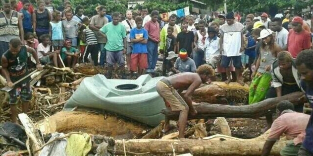 Solomon Islanders in Honiara recover what they can from the debris left by floodwaters.