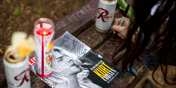 Portland resident Kim Hoffman pays tribute to Kurt Cobain on a bench near the home where the singer died.
