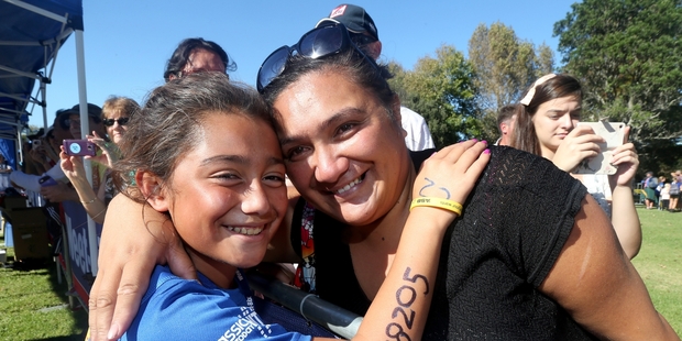 Jorden Edmonds-Griffiths gets a hug from her mother, Leef, at the TRYathlon finish line. Photo / Jason Oxenham