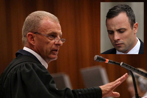 Prosecutor Gerrie Nel, left, earned his reputation as the 'pit-bull' for his gruelling questioning of Oscar Pistorius, during the athlete's third day in the witness box. Photo / AP