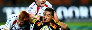 HAMILTON, NEW ZEALAND - APRIL 12: Augustine Pulu of the Chiefs is tackled by Nic Stirzaker of the Rebels during the round nine Super Rugby match between the Chiefs and the Rebels at Waikato Stadium o