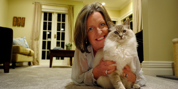 Avenues cat lover Michelle McDonnell, with her cat, Andy, supports a plan to force people to microchip and register their cats. Photo/George Novak