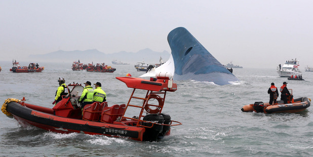 South Korean coast guard officers and rescue team members try to rescue passengers from the ferry Sewol. Photo / AP