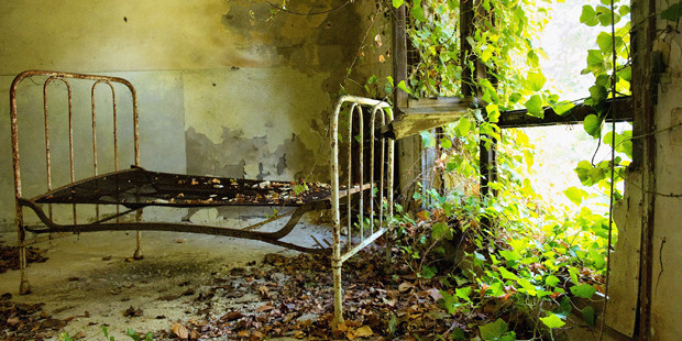 A bed remains in one of the dormitories in the psychiatric ward of the abandoned Hospital of Poveglia in Venice. Photo / Getty Images