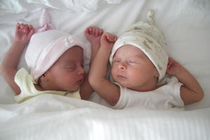 The Ashcrofts' twin daughters Nicole (left) and Peta in India shortly after they were born and Kali Ashari (left), their surrogate mother, feeding Peta.
