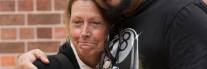 Gail Lees receives a hug from her deceased brothers flatmate and landlord Koro Erika. Photo / Greg Bowker