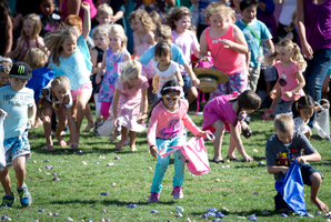 Children scrambled as thousands of Easter eggs were dropped from a helicopter onto North Harbour Stadium during the Egg Day Out. Photo / Richard Robinson