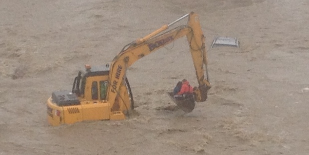 A woman is rescued from the roof of her car in Fuschia Creek after the Kakanui River, Otago. Photo / Otago Rescue Helicopter