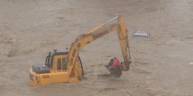 A woman is rescued from the roof of her car after the Kakanui River in Otago flooded. Photo / Otago Rescue Helocopter