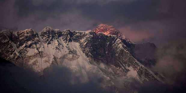 The last light of the day sets on Mount Everest as it rises behind Mount Nuptse as seen from Tengboche. Photo / AP