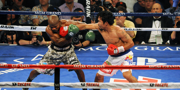 In this photo by the Las Vegas News Bureau, Timothy Bradley, left, and Manny Pacquiao battle during their 12 round World Boxing Organization welterweight title bout. Photo / AP