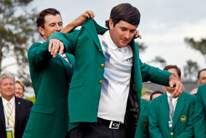 Defending champion Adam Scott helps Bubba Watson into his green jacket. Photo / AP