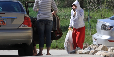 A unidentified person carries a bag from the house where seven infant bodies were discovered. Photo / AP