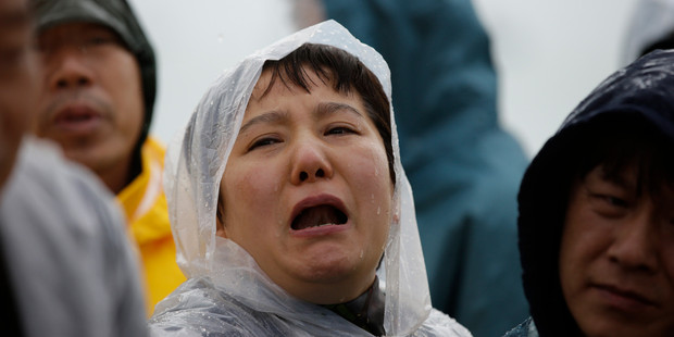 Relatives of passengers aboard a sunken ferry weep at a port in Jindo, south of Seoul, South Korea. Photo / AP