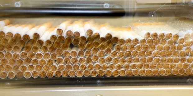 Freshly cut cigarettes make their way through a machine at Imperial Tobacco, Petone, Wellington. Photo / Hagen Hopkins.