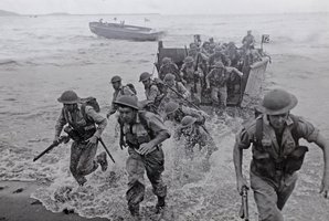 New Zealand forces in the Pacific race ashore from landing craft.