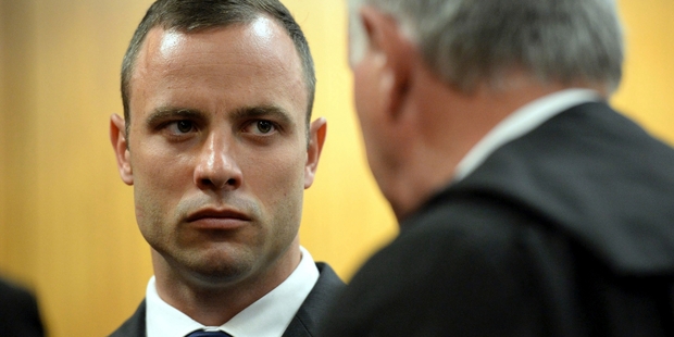 Oscar Pistorius consults his defence attorney Barry Roux at the High Court in Pretoria.Picture / AP
