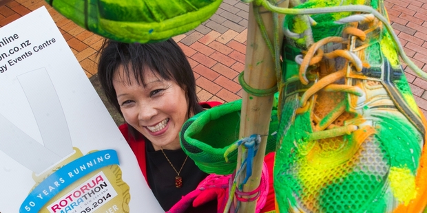 Asics Expo organiser Sandra Kai Fong says the expo is a rare opportunity for local businesses. She is pictured beside one of the shoe trees erected in the CBD to promote the marathon. Photo/Stephen Parker