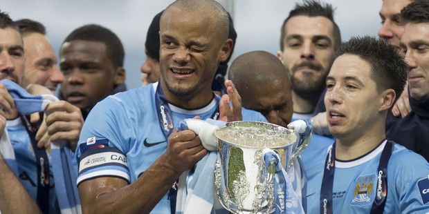 Manchester City players, celebrating with the 2014 League Cup, are on average the highest paid in sport. Photo / AP